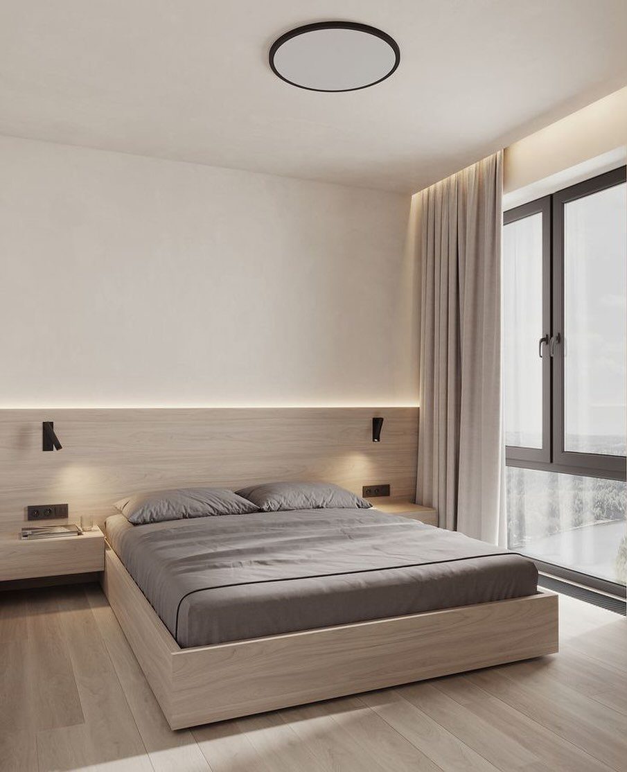 Minimalist light wood platform bed frame with integrated headboard in a modern bedroom.