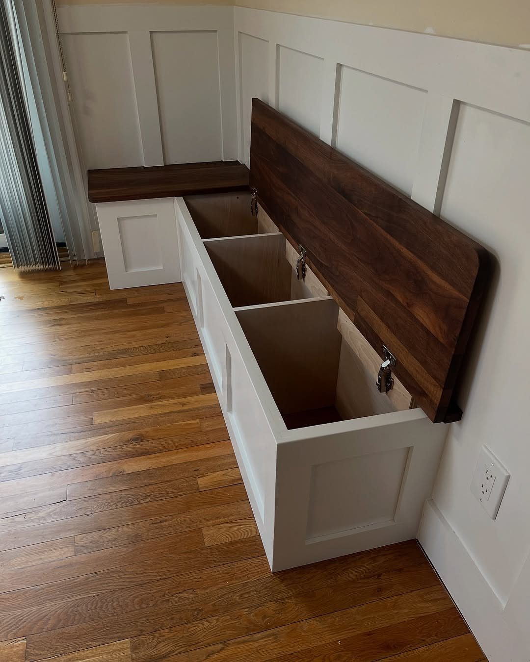 White wooden storage bench with an open dark wood lid revealing three internal compartments.