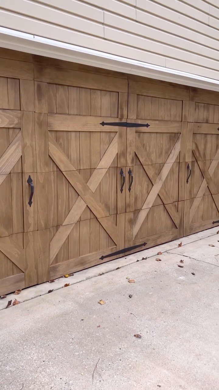 9 Garage Door Makeover Ideas for Instant Curb Appeal 4 Wooden garage door with black decorative handles and long horizontal strap hinges.