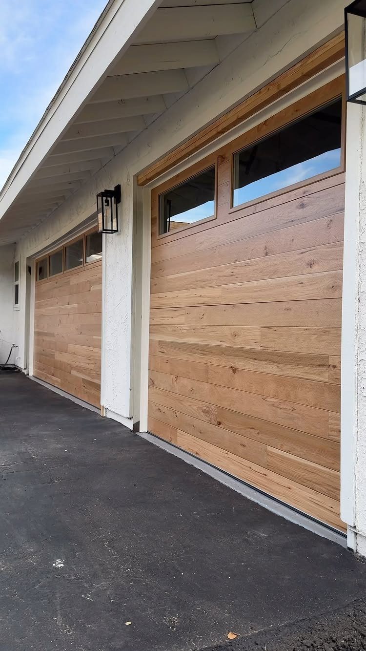 9 Garage Door Makeover Ideas for Instant Curb Appeal 2 Two modern garage doors featuring a light brown wood grain finish and upper windows.