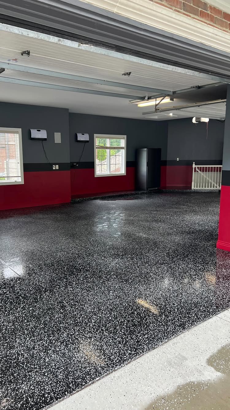 9 Garage Paint Colors for Doors, Floors, Walls and Ceiling 9 A garage with grey and red walls and a black speckled epoxy floor.