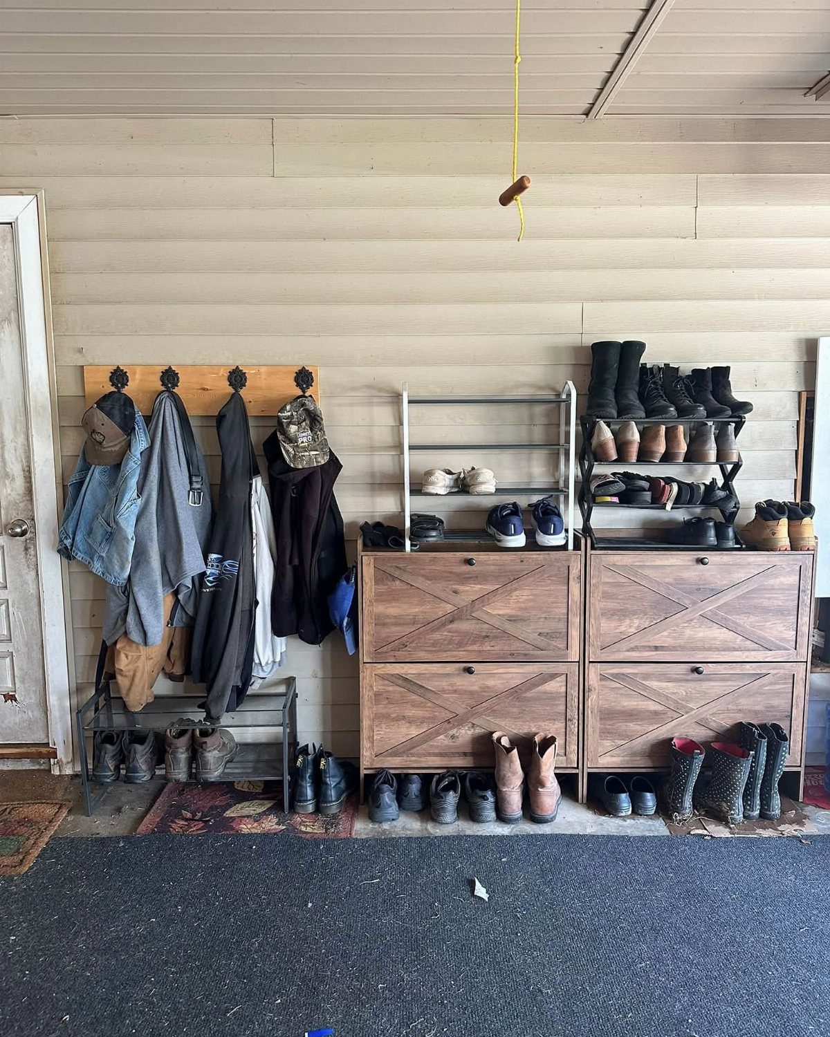 Wooden shoe cabinets with X-patterned doors holding various footwear in a garage setting.