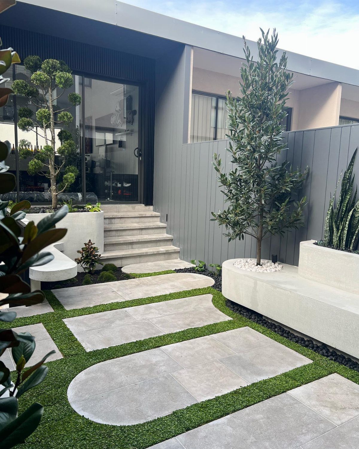 13 Landscaping Plans Layout Ideas to Draw From 4 Large irregular stone pavers set in green grass within a modern courtyard garden.