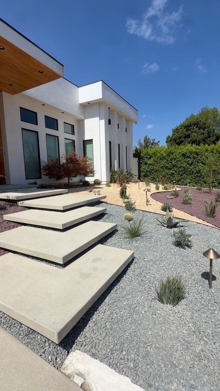 Modern Landscape Design: 12 Ideas for a Contemporary Yard 2 Large concrete pavers create a geometric path through a modern landscape of gravel and succulents.