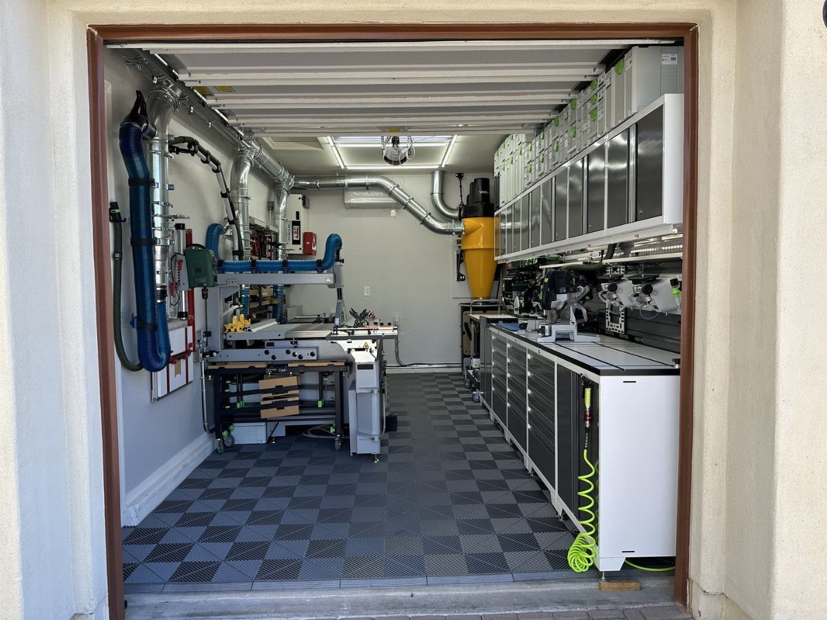 12 One Car Garage Workshop Layout Ideas That Save Space 11 A professional single car garage workshop with organized cabinetry, workbenches, and industrial vacuum systems.