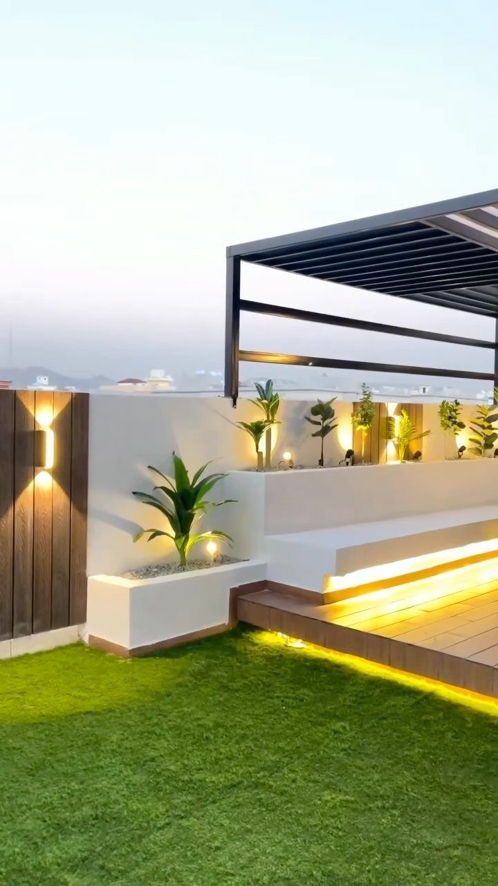 19 Small Backyard Wooden Deck Ideas 14 Modern rooftop terrace with wooden decking, artificial grass, and a black pergola structure.
